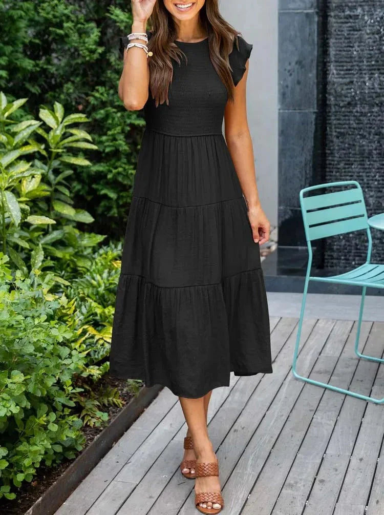 Women's elegant sleeveless smocked midi dress, ideal for warm weather occasions.