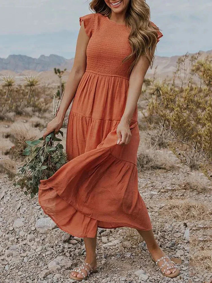 Women's smocked A-line midi dress, perfect for a relaxed yet elegant summer look.