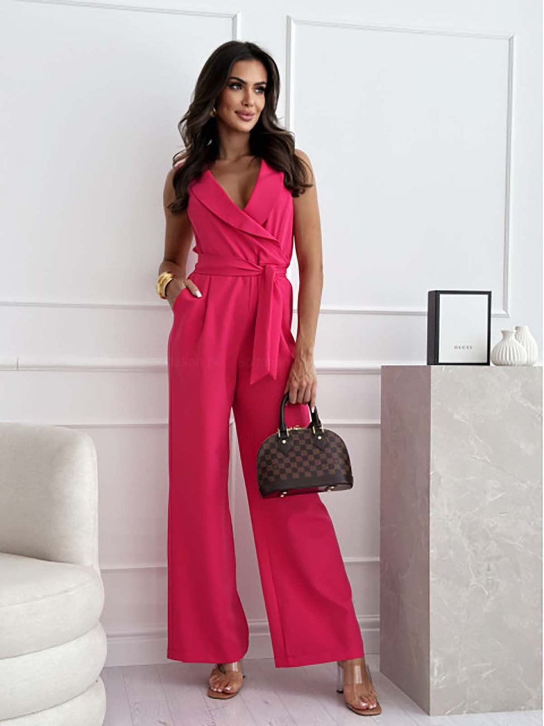 One-piece women's sleeveless V-neck wide-leg jumpsuit with a flattering belted waist & comfortable fit.
