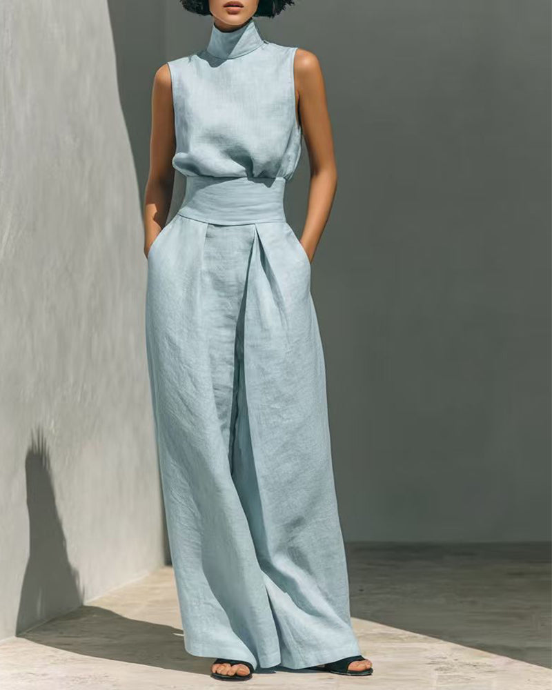 Chic women's sleeveless jumpsuit featuring a flattering wide leg and modern high-waist design. Smart casual look.
