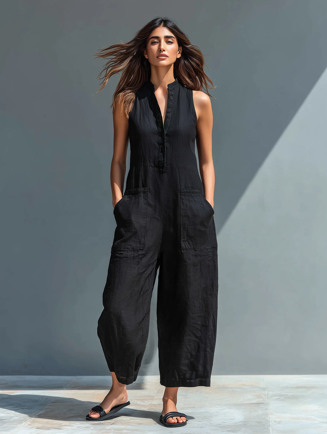 Women's sleeveless wide leg jumpsuit with button front, offering elegant, comfortable & versatile fashion.
