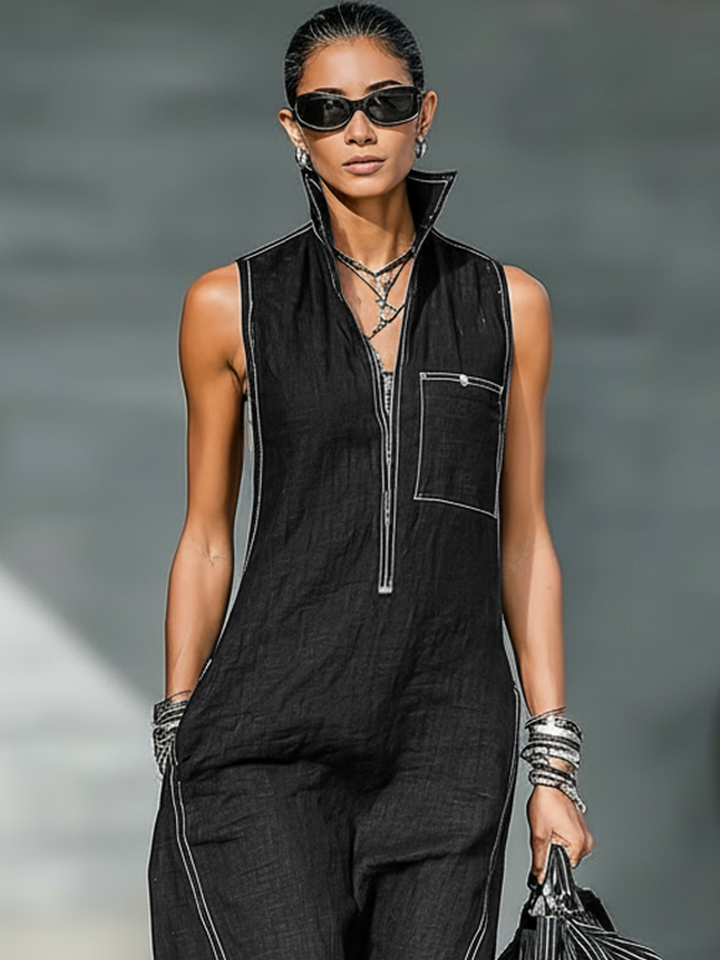 Woman wearing a chic sleeveless wide-leg jumpsuit with white contrast stitching, perfect for a trendy, relaxed outfit.