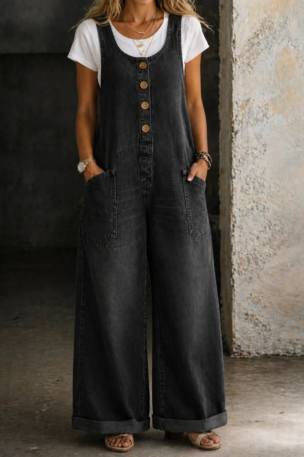 Women's summer style sleeveless wide leg jumpsuit. Features a fashionable button front for effortless wear.