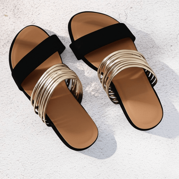 Classic women's slip-on double strap flat sandals, essential summer footwear for relaxed, stylish days.