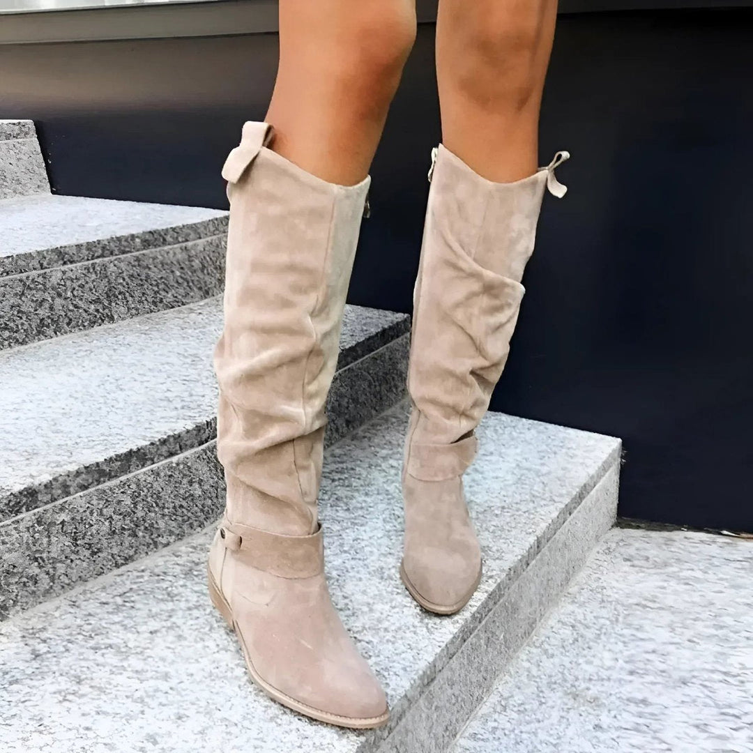 Tall women's knee-high slouchy boots with a sturdy block heel, ideal for casual or elegant winter outfits.