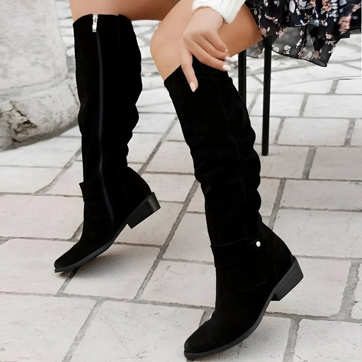 Durable women's knee-high slouchy boots with a comfortable block heel, offering both style and warmth.