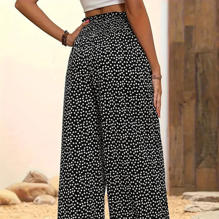 Comfortable and flowy women's trousers, featuring a smocked high waist and wide leg.