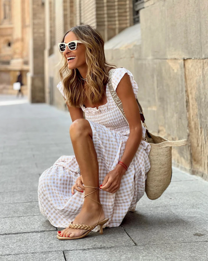 Elegant women's smocked maxi dress, ideal for beach, brunch, or casual summer events.