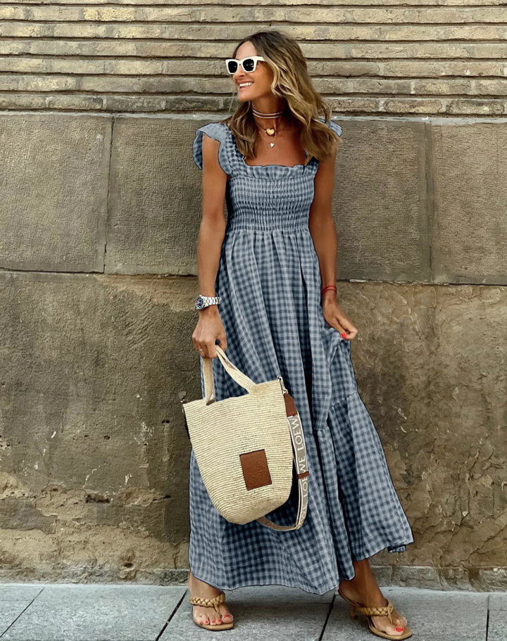 Flowing women's smocked maxi dress, elegant and comfortable for summer days and casual style.