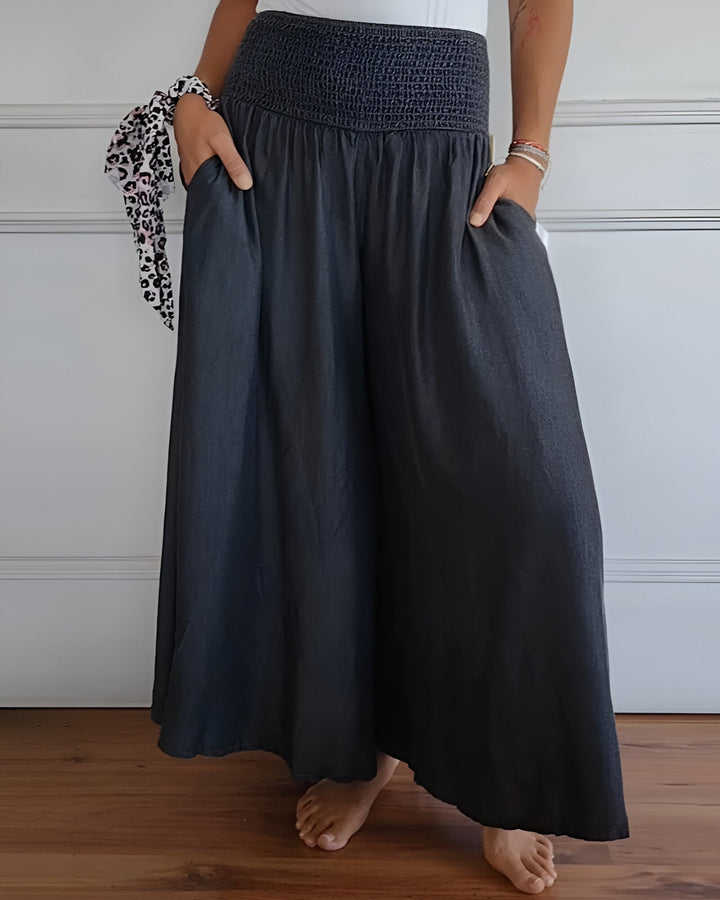 Smocked maxi skirt for women with a wide, comfortable waistband. Flowy long skirt with side pockets for casual wear.