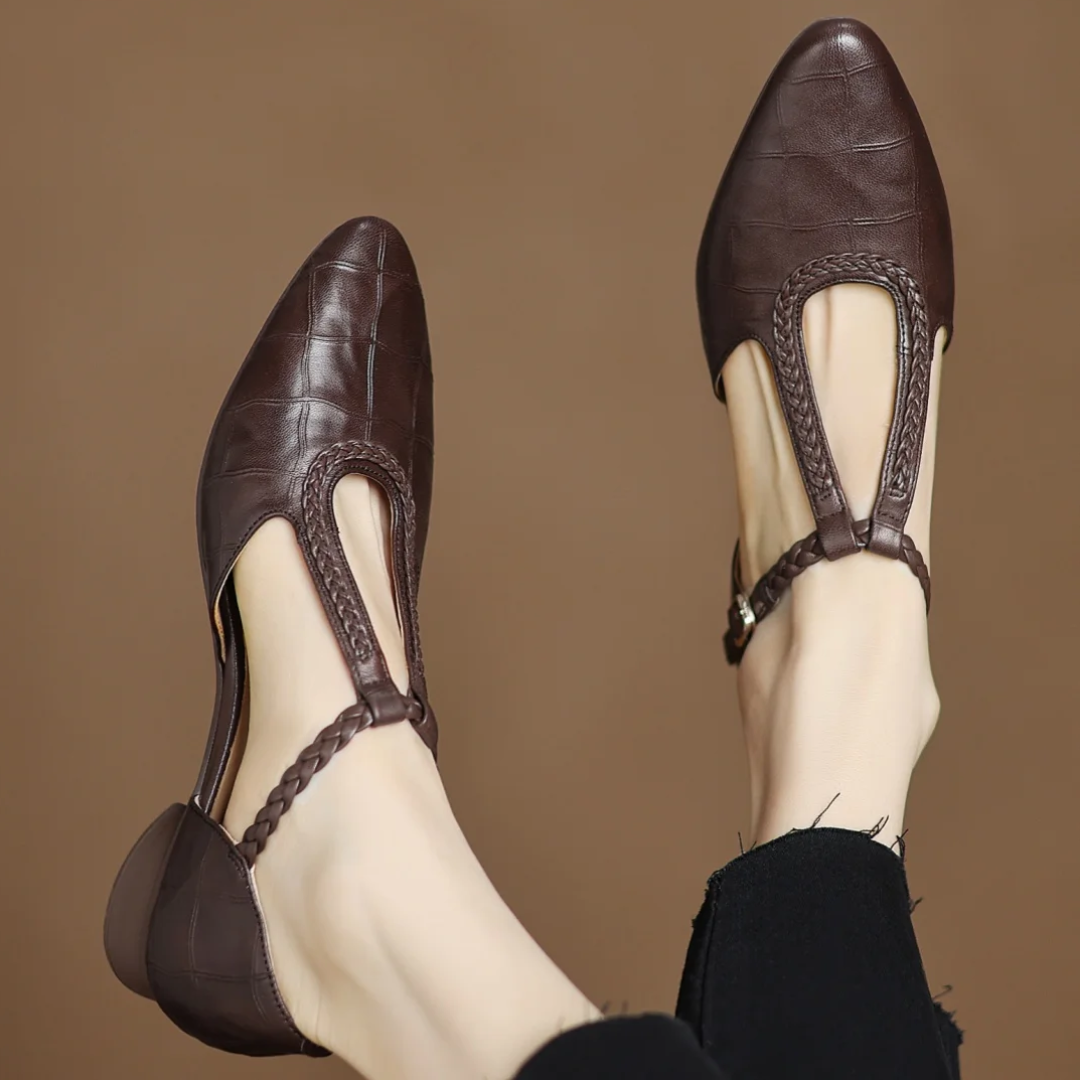 Women's soft leather Mary Janes with braided T-strap, low heel, and pointed toe.