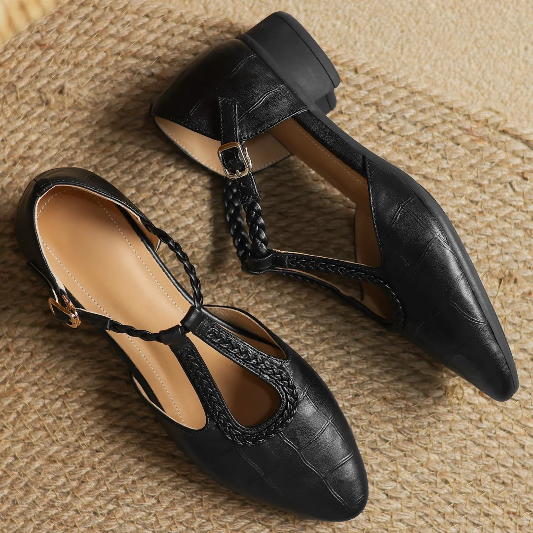 Women's soft leather Mary Janes, low heel, pointed toe, and elegant braided T-strap detail.