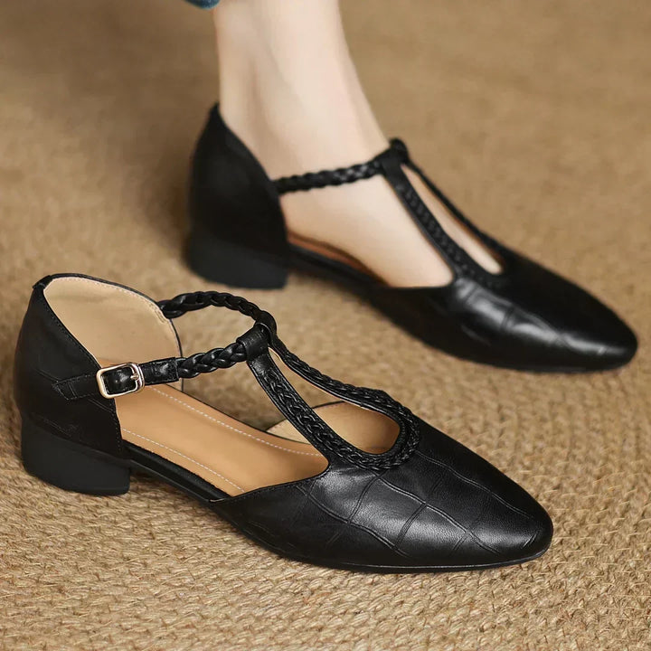 Stylish pointed-toe, low-heel soft leather Mary Janes for women, featuring a braided T-strap.