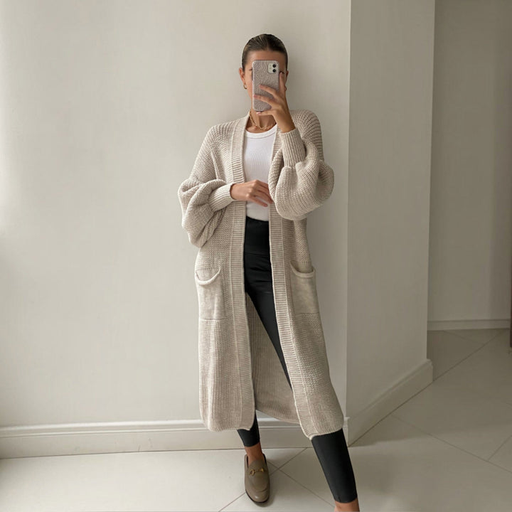 Elegant women's longline cardigan with stylish bell sleeves, a versatile layering piece for comfortable everyday wear.