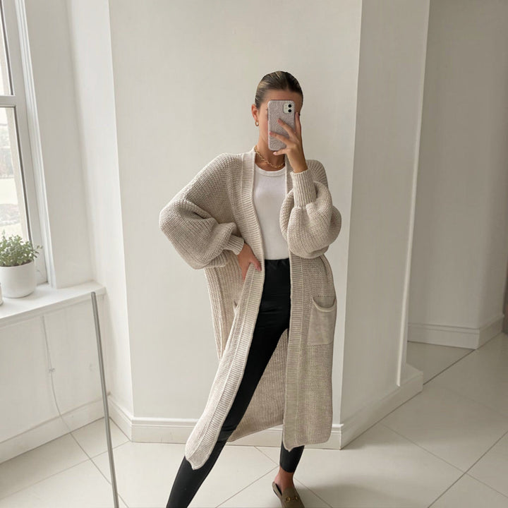 Soft knit longline cardigan for women featuring elegant bell sleeves, perfect for chic, comfortable everyday layering.