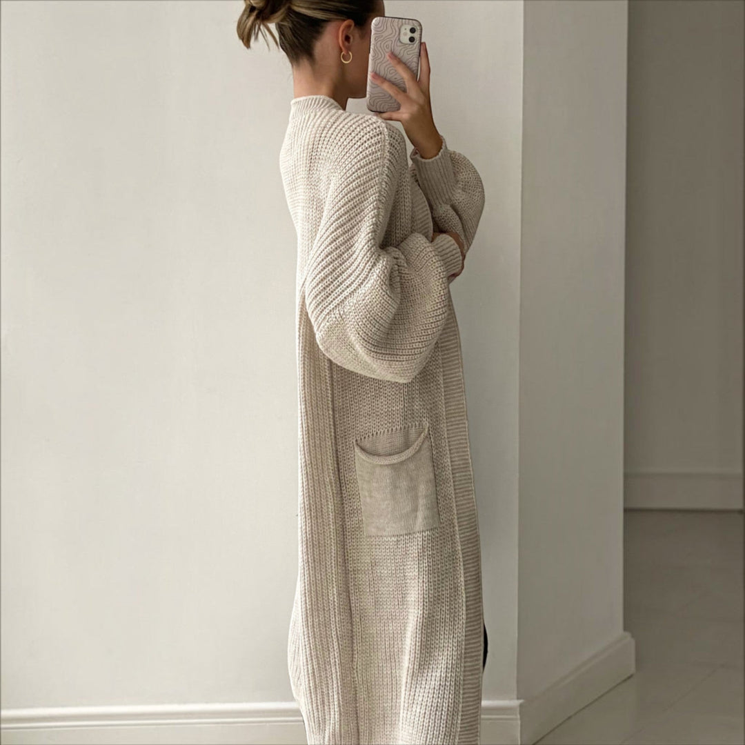 Trendy women's longline cardigan in soft knit, offering elegant style and comfort as a versatile layering piece.