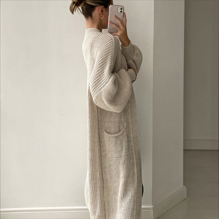 Trendy women's longline cardigan in soft knit, offering elegant style and comfort as a versatile layering piece.