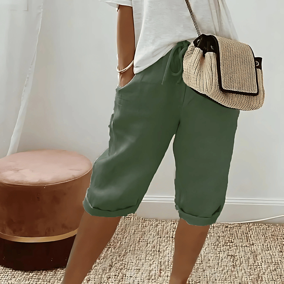 Soft, solid color knee-length women's harem shorts with a high-waist drawstring, ideal for casual comfort.