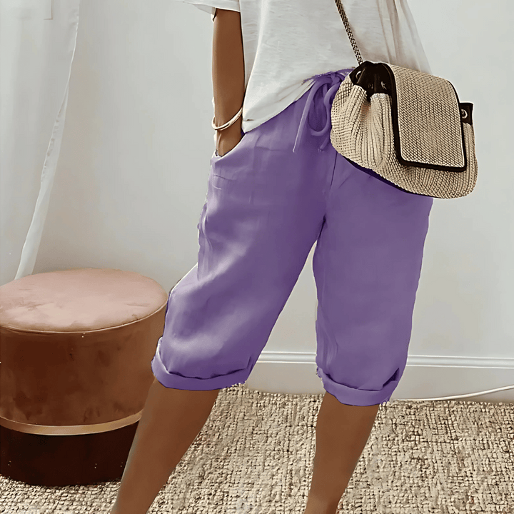 Woman wearing comfortable knee-length harem shorts with a drawstring waist, perfect for relaxed summer and casual outfits.