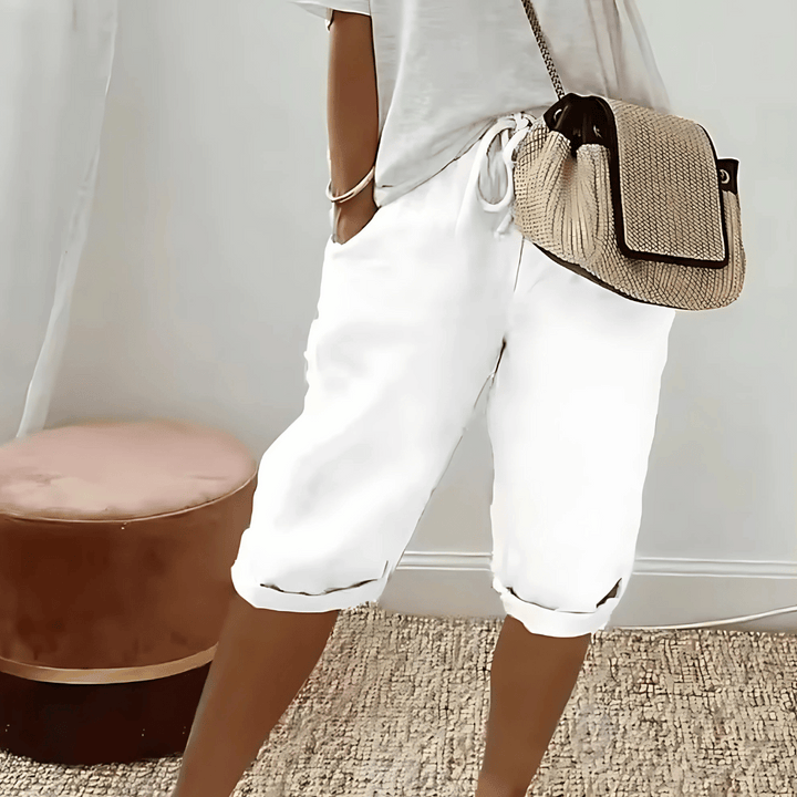 Stylish women's knee-length harem shorts with a relaxed fit & drawstring waist, offering effortless comfort for summer.