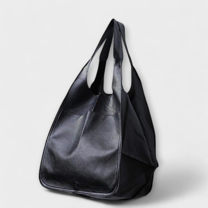 Women's spacious faux leather tote bag in a classic color, perfect for everyday elegance.