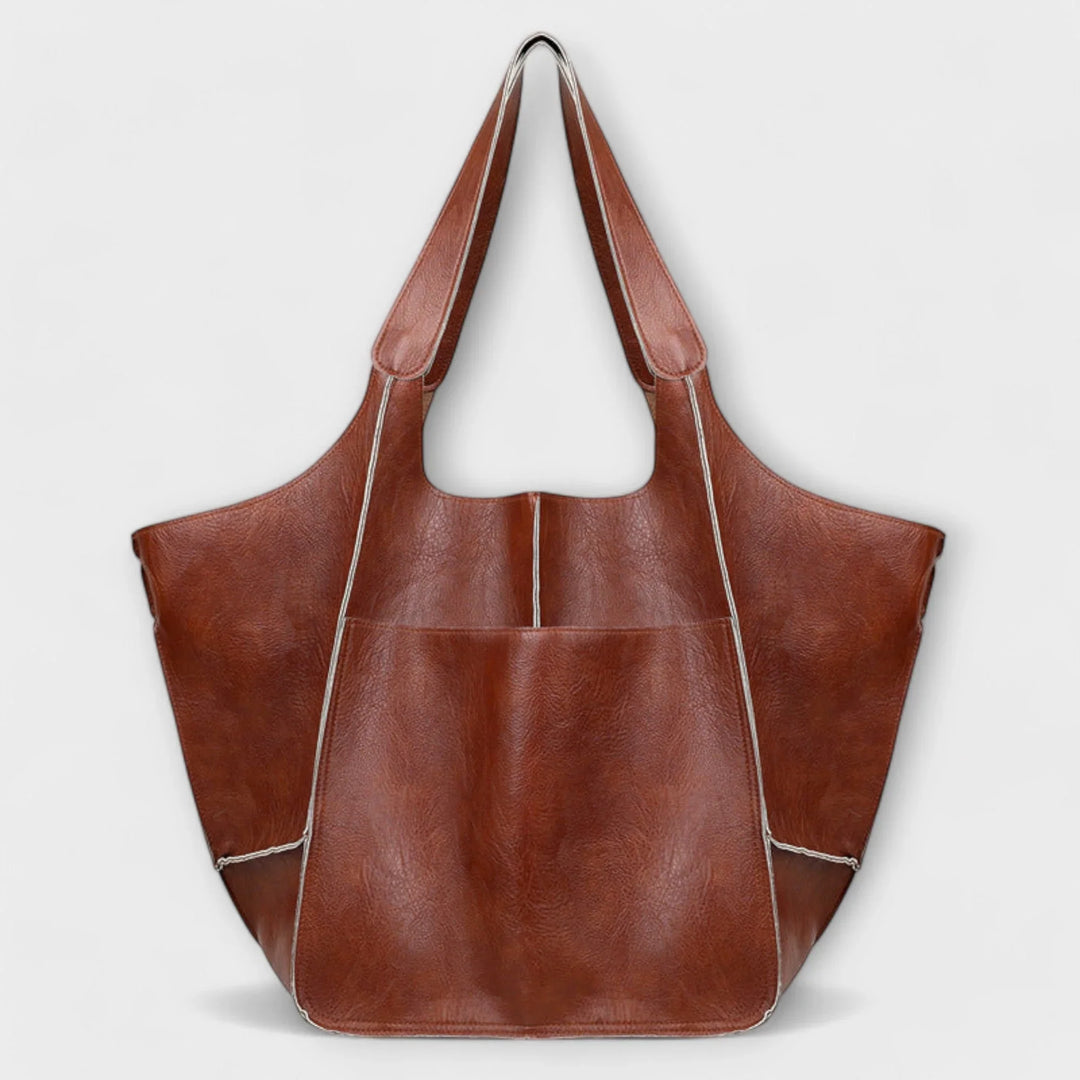 Women's large faux leather tote bag, elegant minimalist design for versatile daily use.