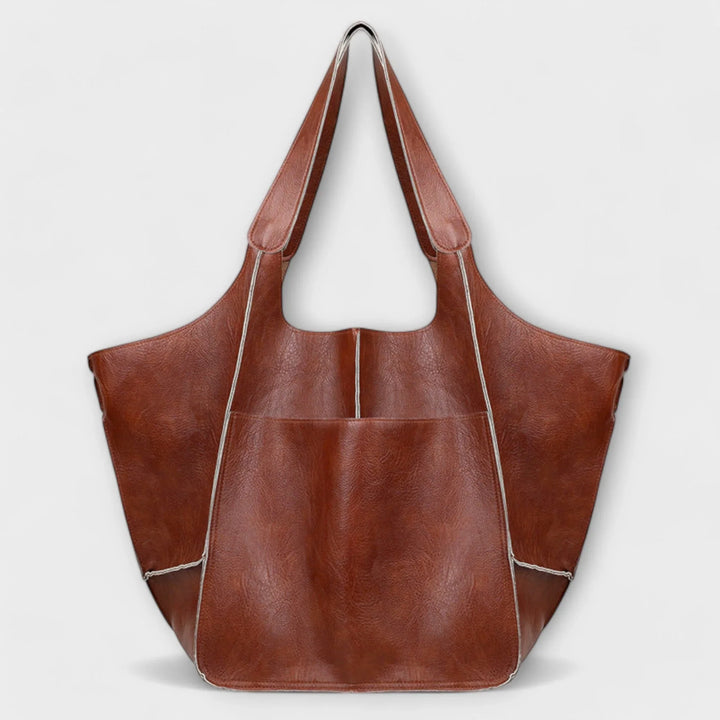 Women's large faux leather tote bag, elegant minimalist design for versatile daily use.