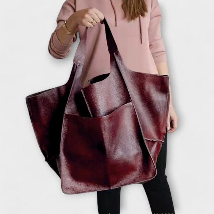 Chic women's faux leather tote bag, spacious & versatile, great for travel or daily commuting.