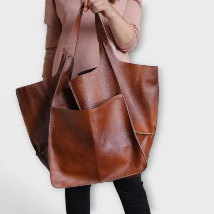 Gray faux leather women's tote, minimalist design with spacious interior for daily elegance.