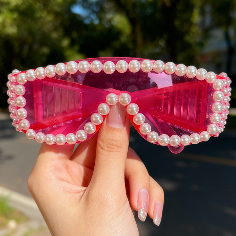 Rhinestone-studded women's sunglasses; sparkling, glamorous fashion accessory with UV protection. Perfect for parties.