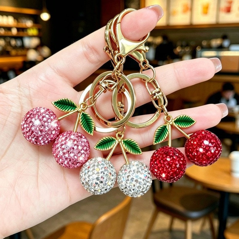 Elegant cherry charm keychain, sparkling glitter accessory for women's bags, a stylish fashion keyring.
