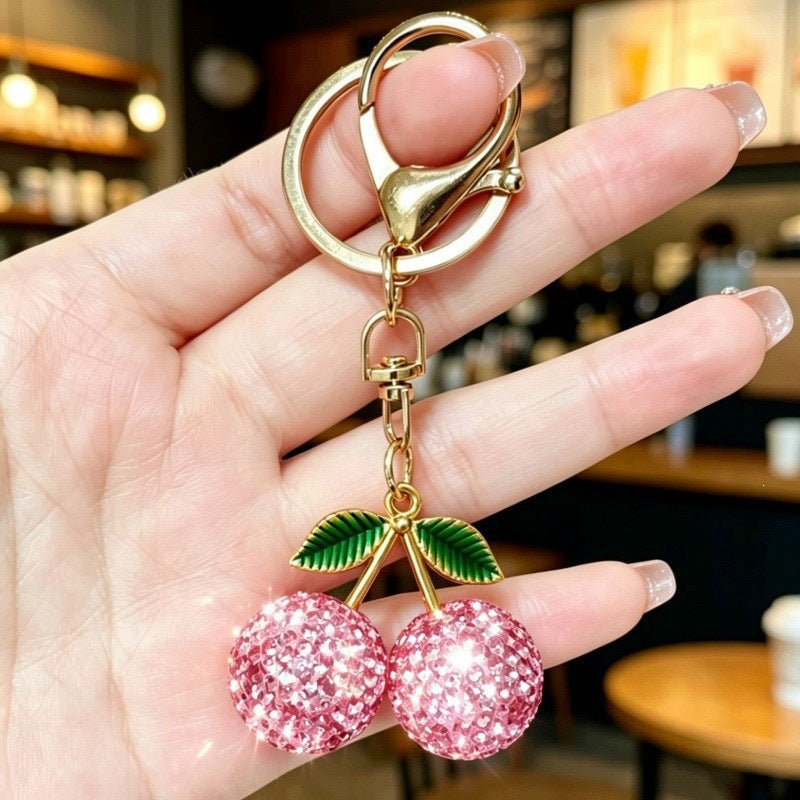 Sparkling cherry keychain, a glittering women's bag accessory and elegant gift idea for fashion lovers.