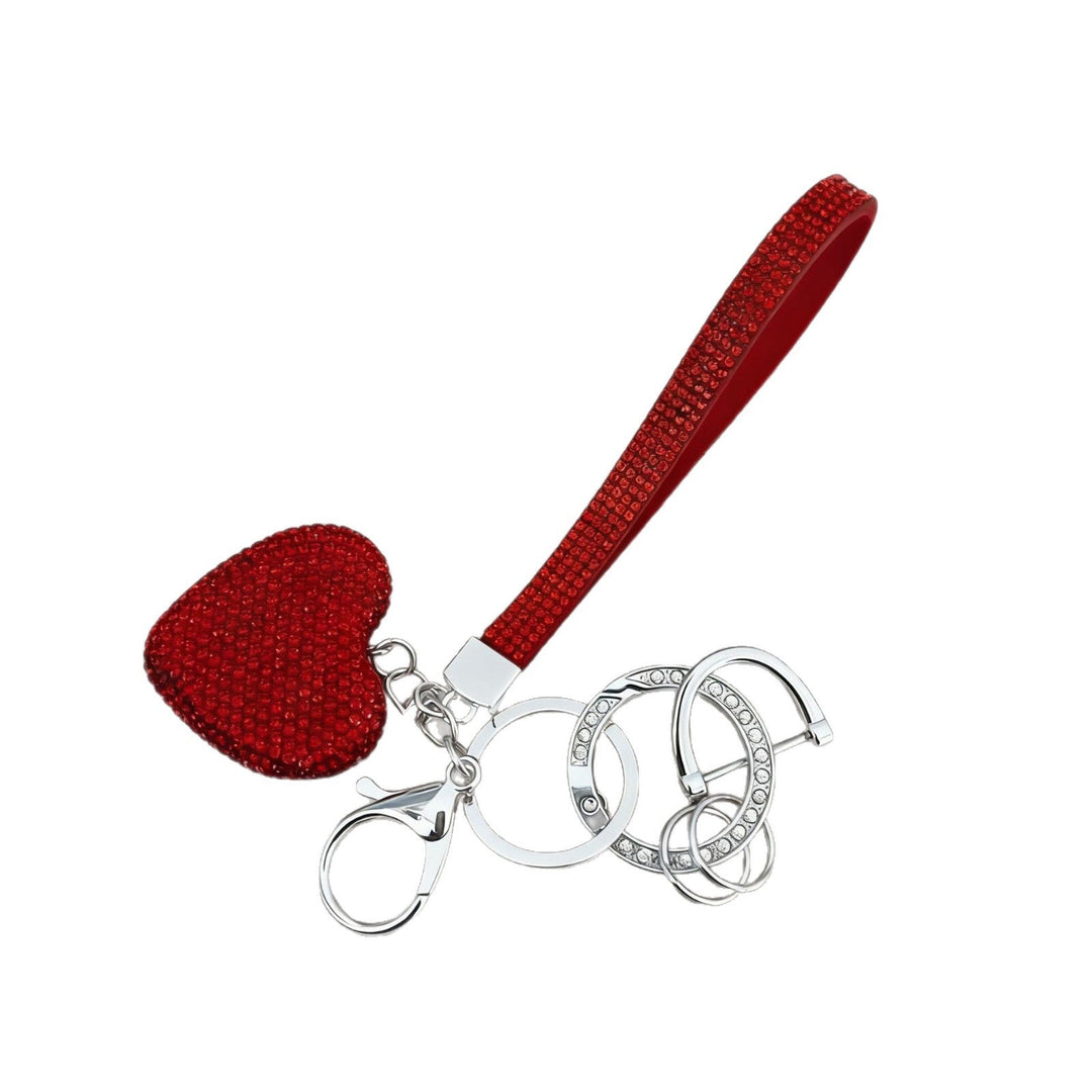 Close-up of a sparkling red & white heart rhinestone keychain, a chic decorative accessory.