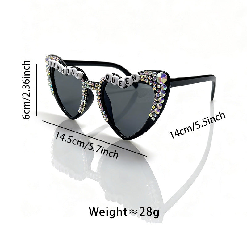 Glamorous women's heart-shaped sunglasses with sparkling rhinestones, a trendy fashion accessory.