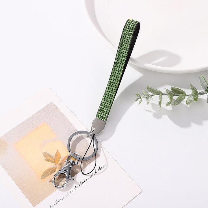 Glamorous women's accessory: a rhinestone keychain holder that shines brightly on bags.