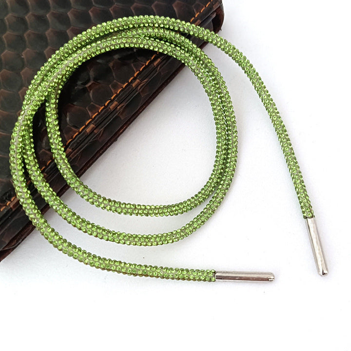 Close-up of sparkling rhinestone shoe laces, showing glitter and bling, ideal for women's footwear customization.
