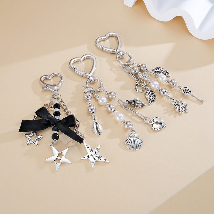 Glittering silver & black star keychain, elegant women's bag charm & key holder, perfect fashion accessory.