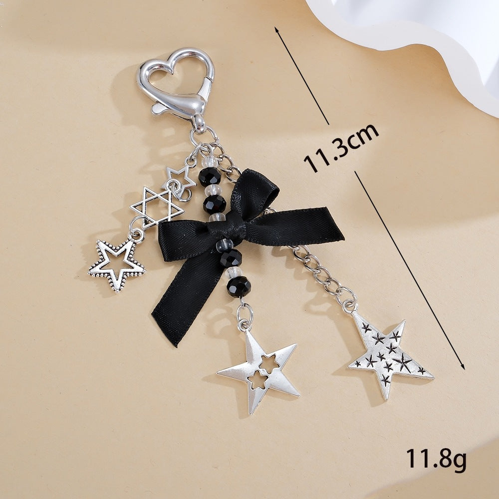 Stylish women's star keychain featuring a sparkling glitter finish & elegant black bow, a perfect fashion gift.