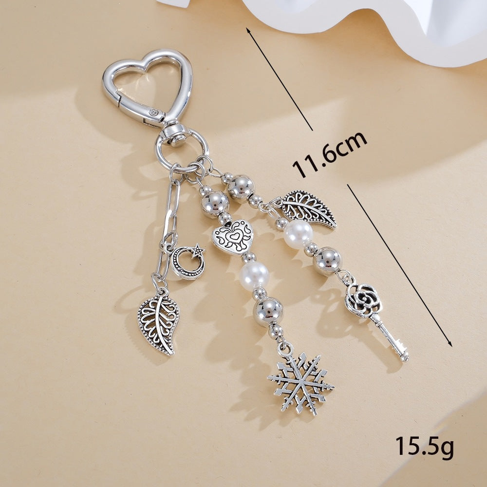 Close-up of a glittering star keychain with an elegant black bow. A sophisticated women's bag charm or key holder.