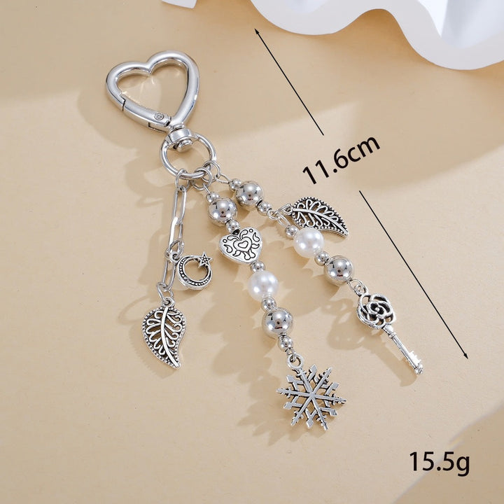 Close-up of a glittering star keychain with an elegant black bow. A sophisticated women's bag charm or key holder.