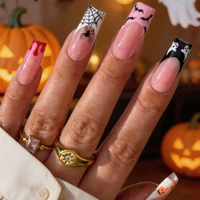 Women's spooky Halloween press-on nails set, featuring ghost & pumpkin art on nude pink acrylics. Festive costume accessory.
