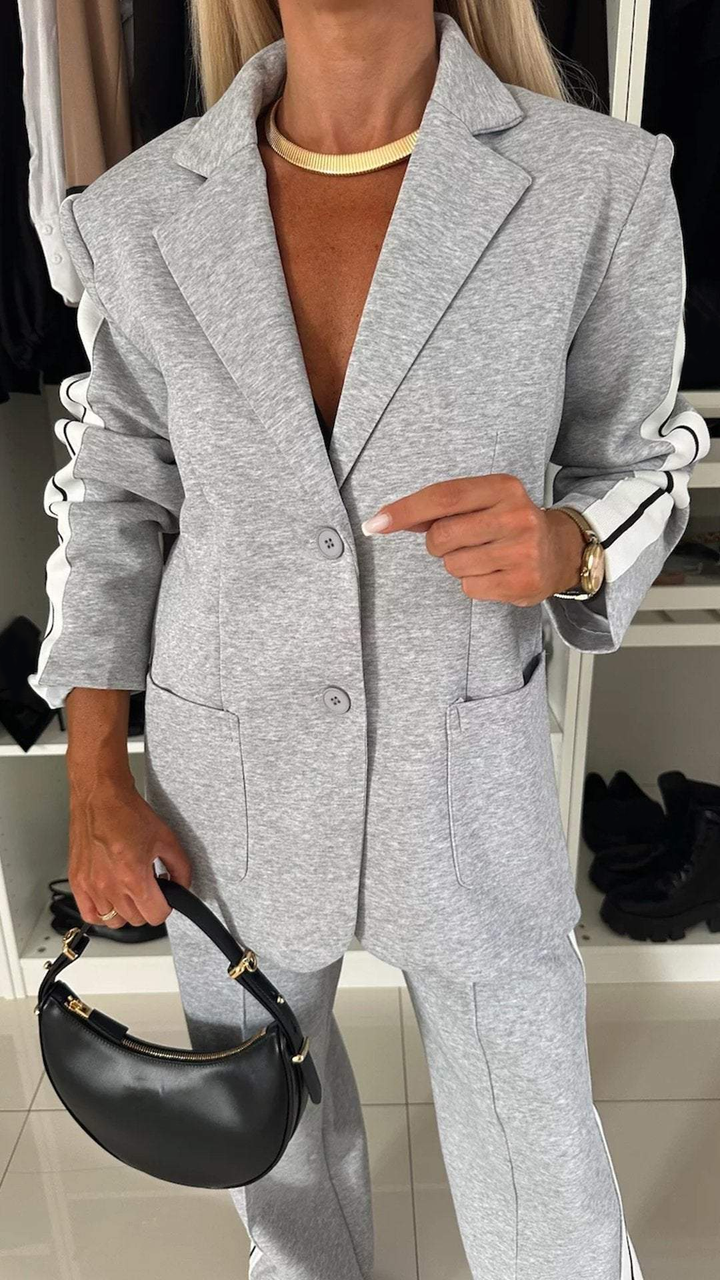 Sporty women's suit set featuring an oversized blazer & striped trousers. Casual elegant urban luxe fashion.