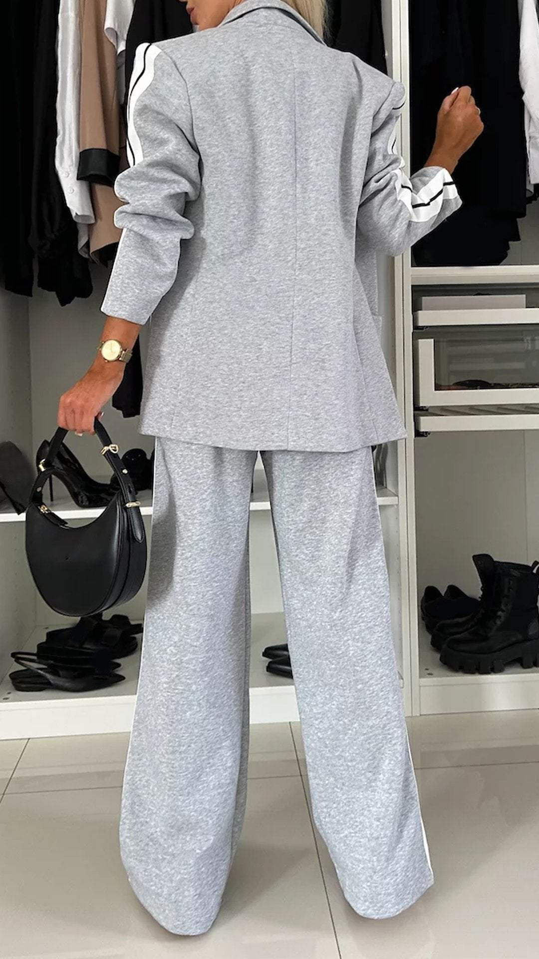 Versatile women's sporty chic suit set. Modern two-piece with oversized blazer and striped trousers.