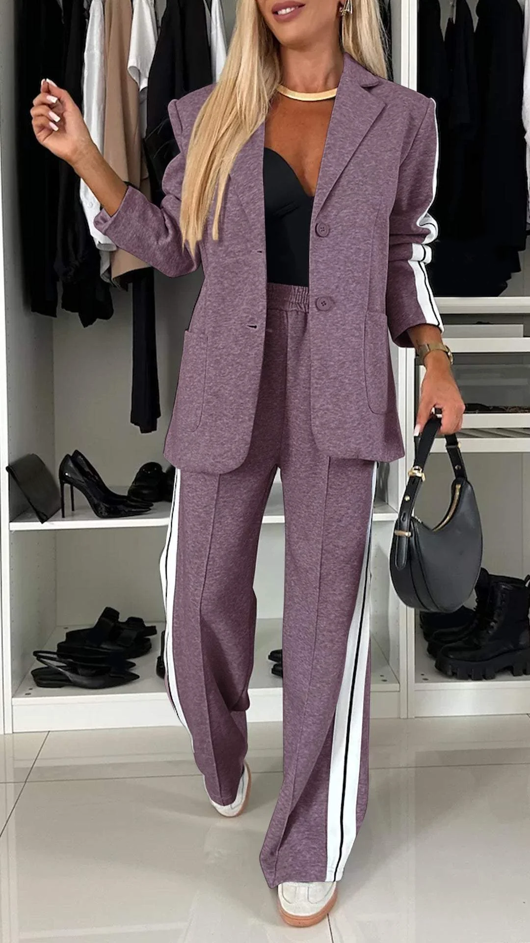 Modern women's trouser suit set. Sporty chic oversized blazer & striped trousers for versatile fashion.