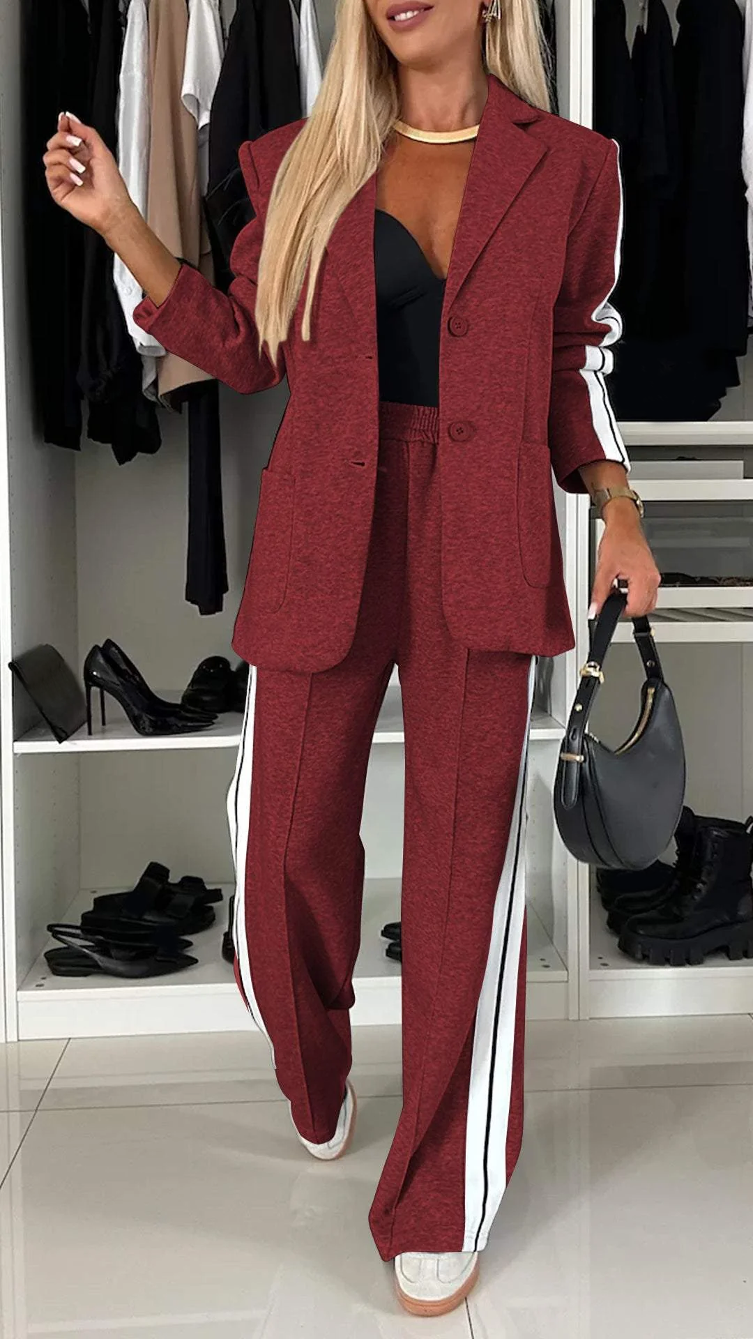Model in women's sporty chic suit set. Flowy striped trousers & oversized blazer, modern fashion urban luxe.