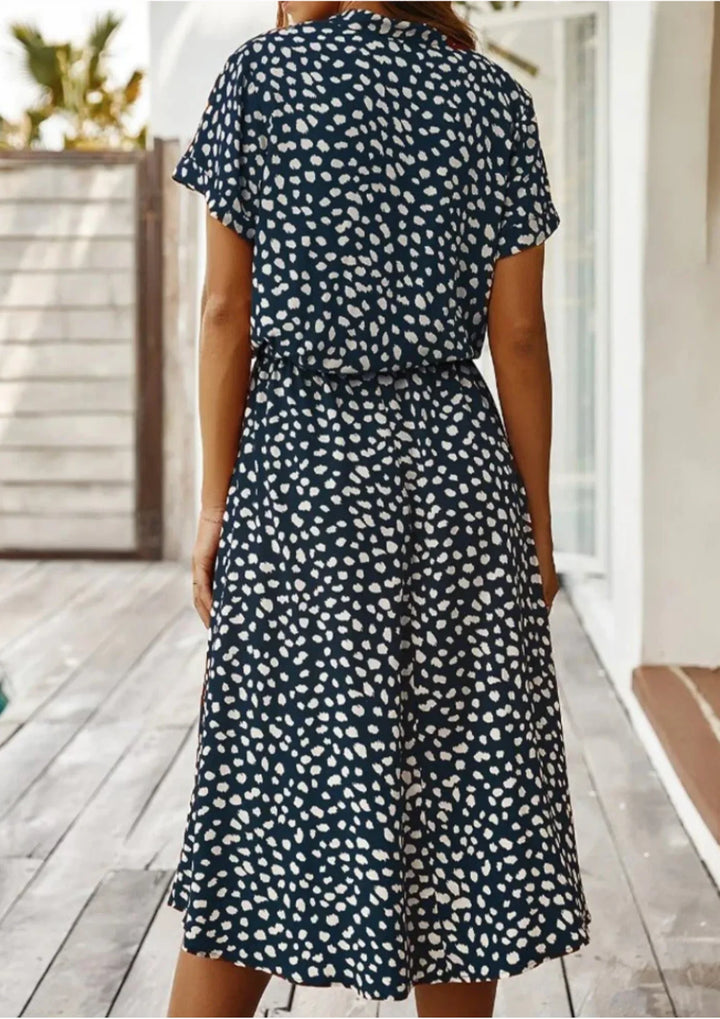 Classic women's spotted print midi dress, featuring a button-down front and a flattering cinched drawstring waist.