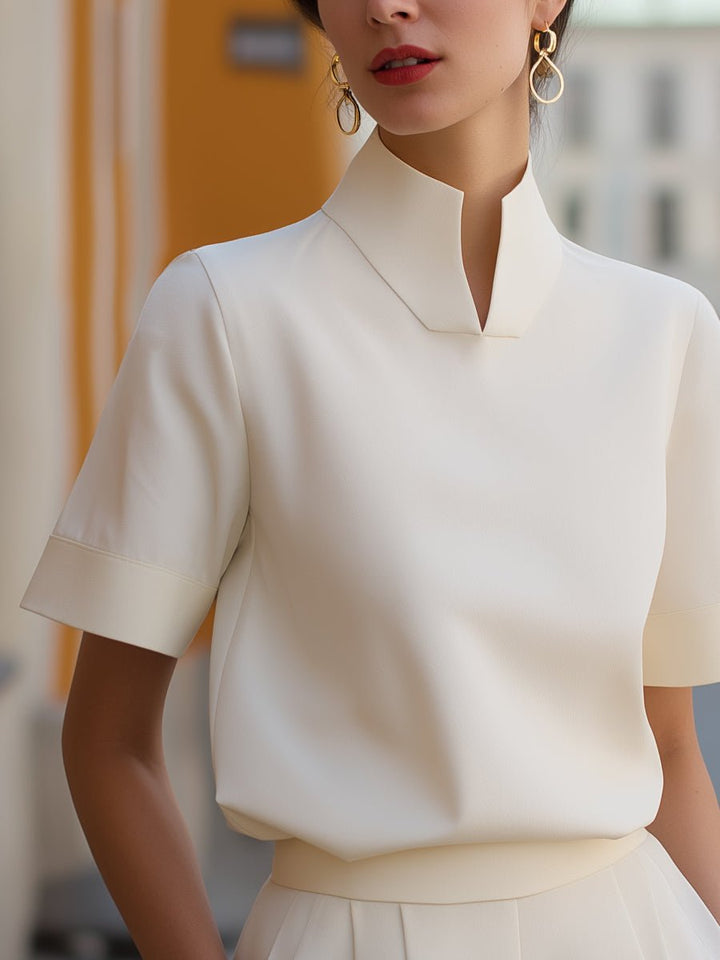 Elegant women's structured blouse with stand collar & short sleeves, perfect for workwear.