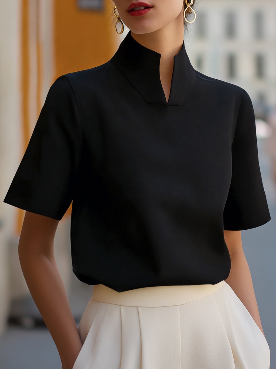 Stylish women's short-sleeve structured blouse with stand collar; versatile for professional settings.