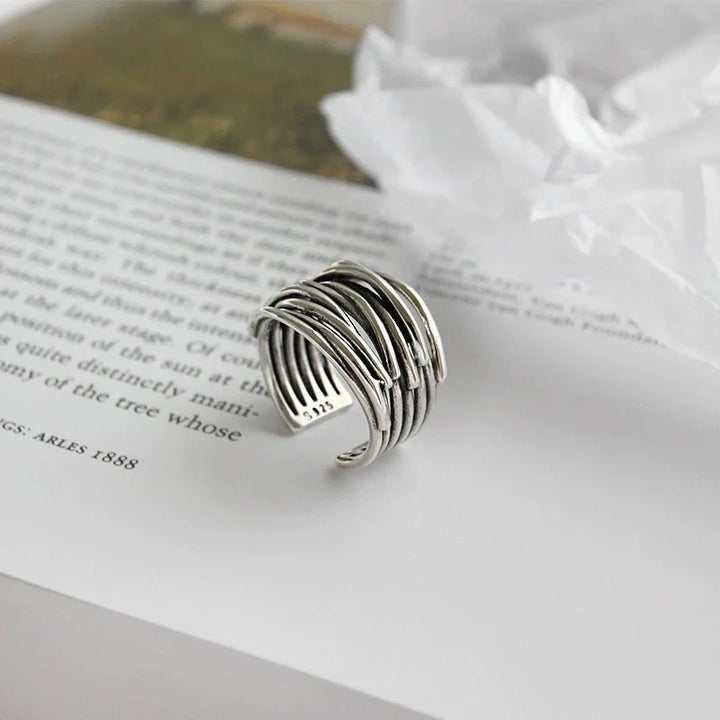 Stylish women's sterling silver open cuff ring with a delicate layered design, adjustable for a comfortable fit.