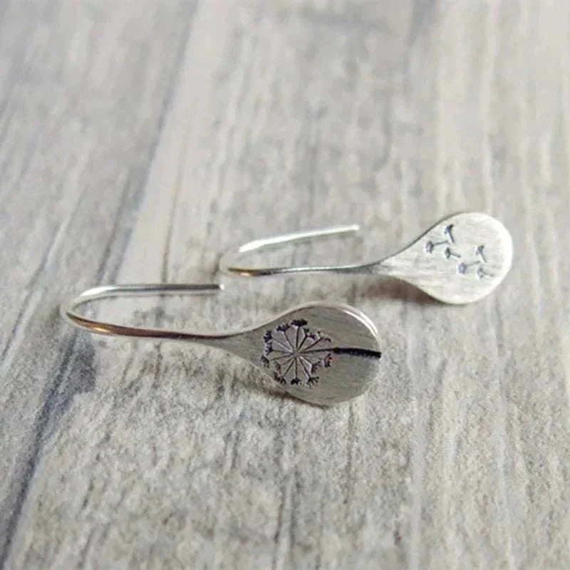 Beautiful sterling silver women's dangle earrings, teardrop shape with real dandelion seeds, nature-inspired jewelry.